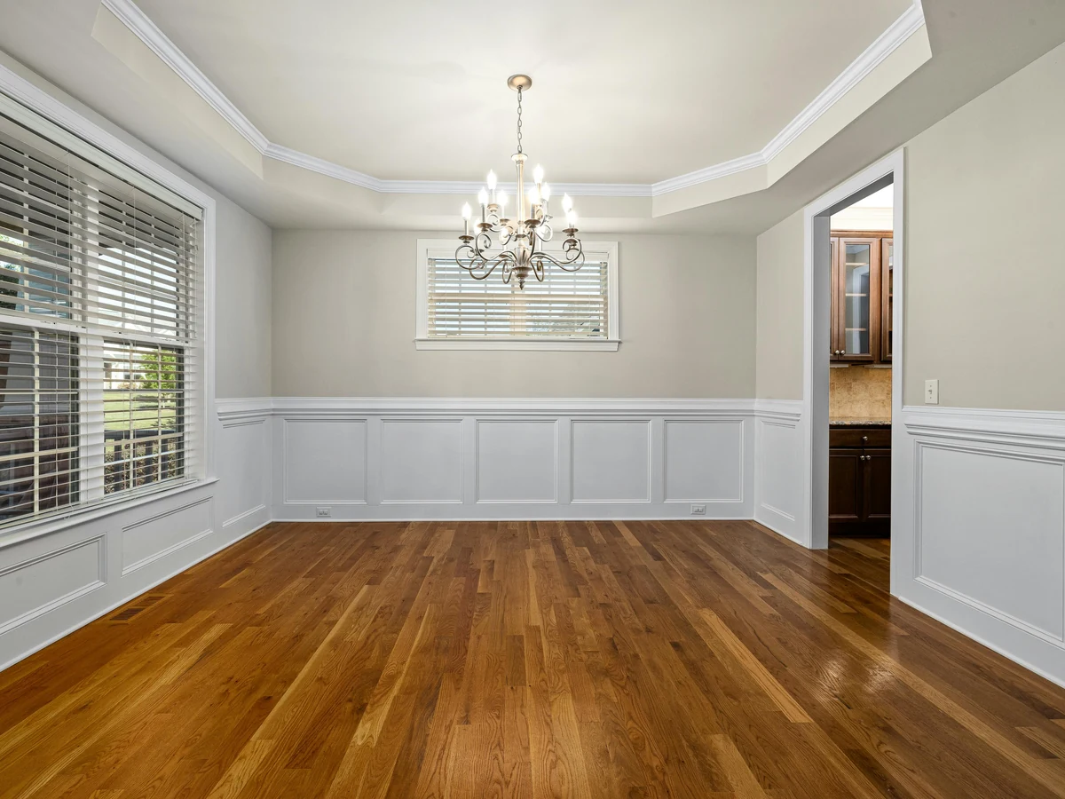 dining-room-painting-greige-walls-white-tray-ceiling-chandelier-empty-room-preston-rose-decor dining room painting greige walls white tray ceiling chandelier empty room preston rose decor