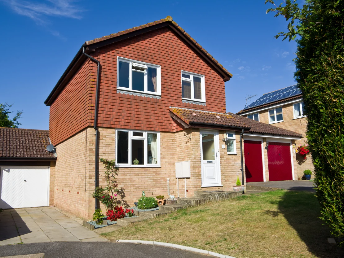 exterior painting suburban detached red brick red garage door front garden preston rose decor