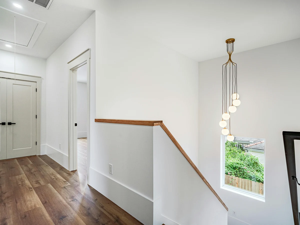 staircase painting white walls wood handrail white skirting modern pendant light preston rose decor